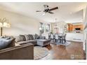 Spacious living room with hardwood floors, L-shaped sectional sofa, and fireplace at 8399 Flora St # B, Arvada, CO 80005