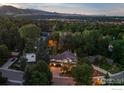 Aerial view of the house with surrounding landscape and distant mountains at 1401 Mariposa Ave, Boulder, CO 80302