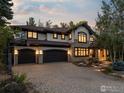 Home exterior featuring a three-car garage and brick driveway at 1401 Mariposa Ave, Boulder, CO 80302