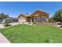 Beautiful house exterior with landscaping and large lawn at 1835 Virginia Dr, Fort Lupton, CO 80621