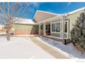 Two-story house with front porch and snowy landscaping at 1885 Parkdale Ct, Erie, CO 80516