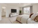 Spacious bedroom with large window, TV stand, and en-suite bathroom at 2262 Base St, Fort Lupton, CO 80621
