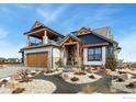 Two-story house with a charming, two-toned exterior and a landscaped yard at 2648 Bluewater Rd, Berthoud, CO 80513