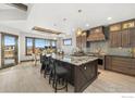Spacious kitchen with granite countertops, wooden cabinetry, and stainless steel appliances at 2648 Bluewater Rd, Berthoud, CO 80513