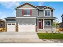 Two-story house with gray siding, red shutters, and a two-car garage at 4101 Marble Dr, Mead, CO 80504