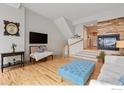 Open living space featuring a fireplace and hardwood floors at 4220 Riley Dr, Longmont, CO 80503