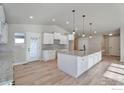 Bright kitchen with white cabinets, granite countertops, and island at 5753 Pintail Way, Frederick, CO 80504
