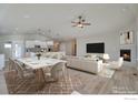 Open living room and dining area with hardwood floors and fireplace at 5753 Pintail Way, Frederick, CO 80504