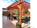 Picturesque patio area with a wooden pergola, comfortable seating, and outdoor dining space at 580 Mount Massive St, Berthoud, CO 80513