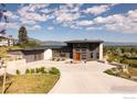 Modern home with mountain views, unique architectural features and a spacious driveway at 7373 Spring Dr, Boulder, CO 80303