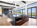 Modern kitchen with large island, stainless steel appliances, and mountain views at 7373 Spring Dr, Boulder, CO 80303