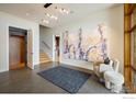 Bright entryway with elevator, staircase, large art piece, and comfortable seating at 825 Circle Dr, Boulder, CO 80302