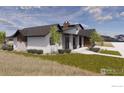Modern farmhouse design, showcasing a side view and landscaping at 975 William Way, Berthoud, CO 80513
