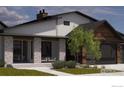Modern farmhouse exterior with stone pillars and landscaping at 975 William Way, Berthoud, CO 80513