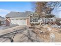 Two-car garage and a well-maintained front yard with landscaping at 10351 Cook Way, Thornton, CO 80229