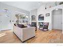 Bright and airy living room with hardwood floors and a fireplace at 10351 Cook Way, Thornton, CO 80229