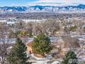 Ranch home with mountain backdrop and snowy landscape at 11454 W 76Th Pl, Arvada, CO 80005