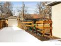A concrete driveway leading to detached garage and fenced yard offering privacy and potential for outdoor activities at 1171 Quebec St, Denver, CO 80220