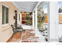 Covered porch with two chairs, snowy yard at 1171 Quebec St, Denver, CO 80220