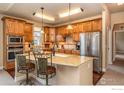 Spacious kitchen with granite countertops, stainless steel appliances, and wood cabinets at 1379 Charles Dr # 7, Longmont, CO 80503