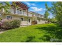 Spacious backyard with lush green lawn, a balcony, and pergola at 1430 Balsam Ave, Boulder, CO 80304