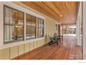 A welcoming front porch with wooden chairs and a view into the house at 1430 Balsam Ave, Boulder, CO 80304