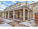 Spacious front porch with wooden columns and a wooden floor, offering curb appeal at 1430 Balsam Ave, Boulder, CO 80304