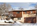 Ranch style home with wood siding and attached garage in winter setting at 1895 Balsam Ave, Boulder, CO 80304