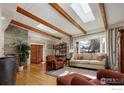 Spacious living room with hardwood floors, exposed beams, and skylights at 1895 Balsam Ave, Boulder, CO 80304