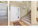 Entryway with staircase, white door, and patterned rug at 1940 Seidler Ct, Erie, CO 80516