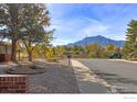 Scenic street view with the iconic Flatirons, beautiful landscaping and mature trees in Boulder, Colorado at 200 Fox Dr, Boulder, CO 80303