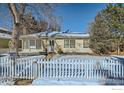 Beige ranch house with white picket fence and snowy yard at 2253 Columbine Ave, Boulder, CO 80302