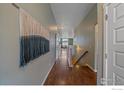 Bright and spacious entryway with hardwood floors and modern wall art at 2321 Nicholson St, Berthoud, CO 80513