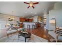 Open concept kitchen with island, hardwood floors, and stainless steel appliances at 2321 Nicholson St, Berthoud, CO 80513