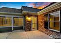 Inviting entryway with stone accents and a sunlit interior at 2481 Santa Fe Dr # C, Longmont, CO 80504