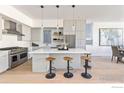 Open-concept kitchen boasts a large island, stainless steel appliances, and modern cabinetry with bar stool seating at 3319 Broadway St, Boulder, CO 80304
