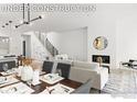 Bright living room featuring a modern fireplace, stylish seating, and elegant decor under a modern chandelier at 3319 Broadway St, Boulder, CO 80304