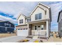 Two-story house with light beige siding, stone accents, and a two-car garage at 399 Blackfoot St, Superior, CO 80027