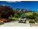 Stone patio with seating area and stunning mountain backdrop at 45 Bellevue Dr, Boulder, CO 80302