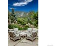 A cozy patio set with comfortable seating offers a relaxing space with mountain views at 45 Bellevue Dr, Boulder, CO 80302