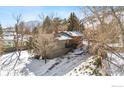 House exterior with snowy landscape, driveway, and mountain views at 536 Linden Park Dr, Boulder, CO 80304