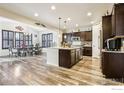 Open concept kitchen with an island, stainless steel appliances, and dark cabinets at 6539 Empire Ave, Frederick, CO 80516