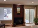 Living room with fireplace and sliding glass door to backyard at 7933 Countryside Dr # 120, Niwot, CO 80503