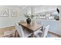 Dining area with a wood table and six light-grey chairs at 105 Indian Peaks Dr, Erie, CO 80516