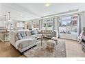 Spacious living room with L-shaped sectional sofa and large windows at 105 Indian Peaks Dr, Erie, CO 80516