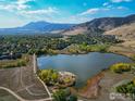 Aerial view of a lake surrounded by autumn trees and mountains at 1095 Quince Ave, Boulder, CO 80304