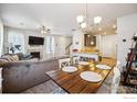 Open dining area with a farmhouse table and access to kitchen at 12794 Leyden St # A, Thornton, CO 80602