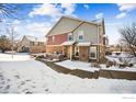 Stunning two-story home with a snow covered front yard at 12794 Leyden St # A, Thornton, CO 80602