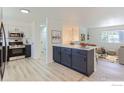 Open kitchen view with an island that flows into the dining and living area at 12802 E Nevada Cir, Aurora, CO 80012