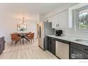 Open concept kitchen featuring stainless steel appliances and an adjacent dining area at 12802 E Nevada Cir, Aurora, CO 80012